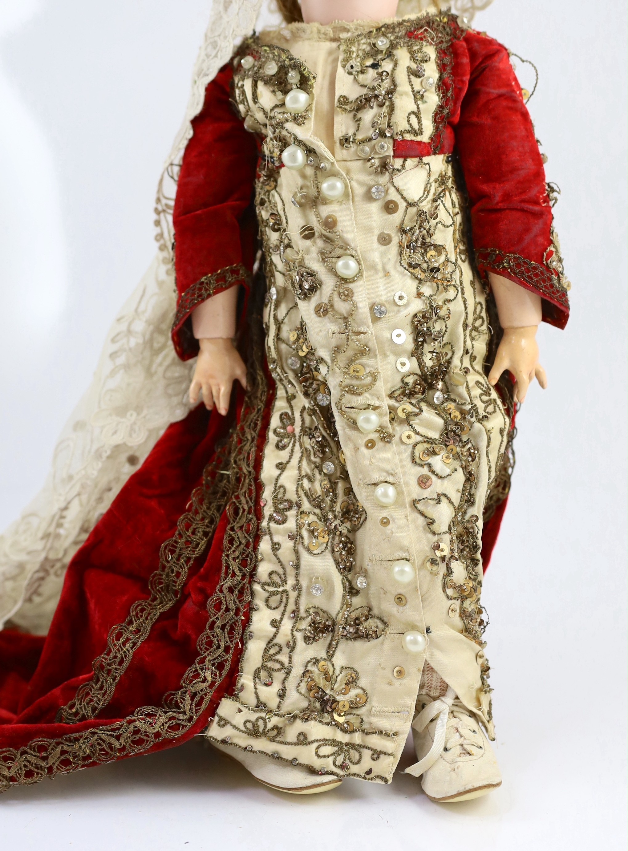 A Simon & Halbig bisque doll, mould 1078, sleeping eyes and open mouth, jointed wood and composition body, sequinned cream and red velvet dress, 19in.